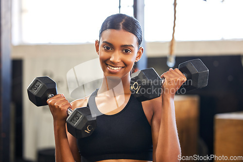 Image of Fitness, dumbbells or portrait of happy woman training, exercise or workout for powerful arms or muscles. Dumbbell curls, strength or Indian girl athlete lifting weights or exercising biceps at gym