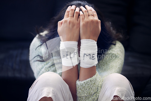 Image of Wrist, depression and woman with help on bandage for suicide, self harm or person in dark mental health crisis. Bandages, girl and injury from depressed accident, problem or mistake in cutting wrists