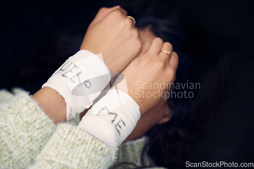 Image of Woman, depression and wrist with help on bandage for suicide, self harm or person in dark mental health crisis. Bandages, girl and injury from depressed accident, problem or mistake in cutting wrists