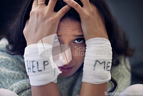 Image of Depression, wrist and woman with help on bandage for suicide, self harm or person in dark mental health crisis. Portrait, girl and injury from depressed accident, problem or mistake in cutting wrists