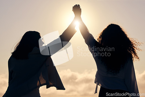 Image of Back silhouette, sunshine and women holding hands for support, success and love in nature. Happy, dark and friends with solidarity, trust and unity on a holiday for friendship or bonding together