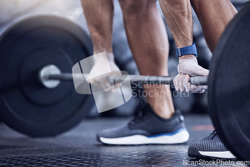 Image of Man, training and hands with weight in a closeup at the club for workout with equipment. Male trainer, barbell and lifting with hand on the floor at a gym for strength with muscles for exercise.