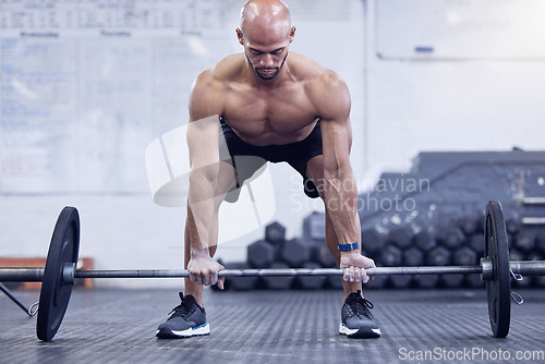 Image of Male athlete, fitness and deadlift at the gym for muscles for a strong body for sport with motivation. Workout, barbell and man is training at a club for exercise with strength for weightlifting.