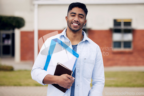 Image of Happy, college and portrait of a man with books on campus for education, learning and studying. Smile, notebook and a student standing at university for scholarship, knowledge and school exam