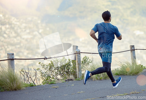 Image of Man running in road, fitness and cardio outdoor, exercise and healthy, active lifestyle with back. Male runner on path to run, train for marathon with speed, energy and workout for health and sport