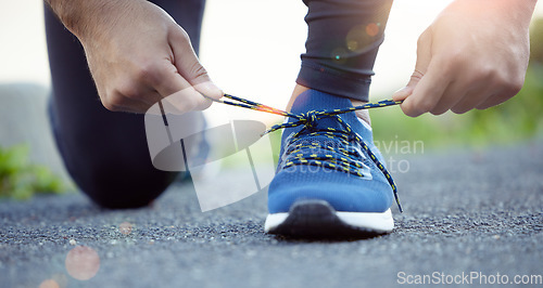 Image of Shoes, hands and man tying shoelace for run, fitness outdoor for exercise, cardio and active with health and closeup. Sports, running sneakers and male person start workout with bokeh and training