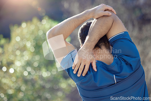 Image of Fitness, back and stretching with a man runner outdoor in the mountains for a cardio or endurance workout. Exercise, sports and warm up with a male athlete getting ready for a run outdoor in nature