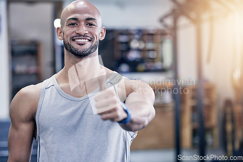 Image of Thank you, portrait of man and with thumbs up at the gym with a lens flare. Success or motivation, agreement or health wellness and male athlete happy for support workout or fitness training