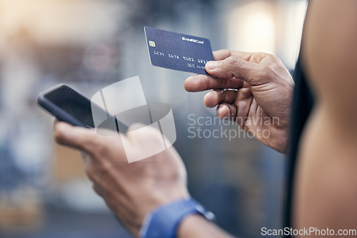 Image of Ecommerce, man with smartphone and credit card for payments at gym with a lens flare. Subscription or membership, closeup and male athlete with cellphone with bank information for online shopping