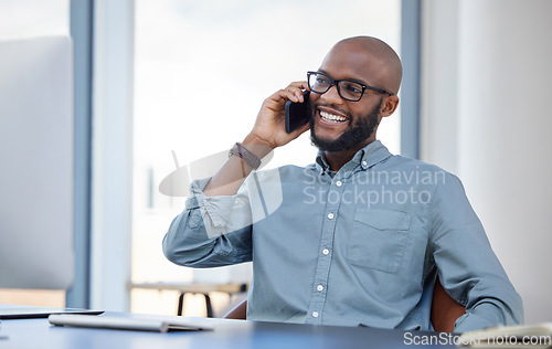 Image of Happy, businessman with smartphone and on a phone call at his desk with computer in workplace office. Online communication, smile and African man with cellphone talking at his modern workspace