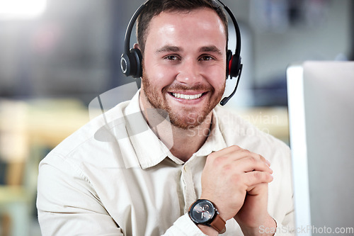 Image of Customer service, portrait of a man with a headset and computer at his desk in a modern workplace office with smile. Telemarketing or online communication, support or crm and male call center agent