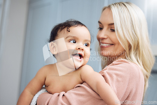 Image of Love, smile and mother holding with her baby in the nursery room of their modern family home. Happy, bonding and young woman hugging her cute girl infant child with care and affection in their house.