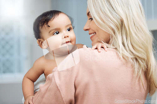 Image of Bonding, love and mother holding her baby in the nursery room of their modern family home. Happiness, smile and young woman hugging a cute girl infant child with care and affection in their house.