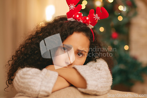 Image of Portrait, sad woman and depression on Christmas in home with anxiety, worry and emotional crisis. Face of lonely female person feeling unhappy, bored and disappointed in festive holiday with headband