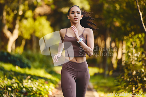 Image of Fitness, woman and running in nature for cardio exercise, workout or training in the outdoor park. Female person, athlete or runner exercising for healthy wellness, run or sports marathon in forest