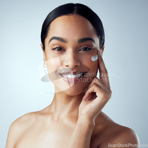 Image of Skincare, face cream and woman in studio for dermatology, wellness or hydration on grey background. Portrait, sunscreen and lady model relax with collagen, mask or lotion, beauty or anti aging facial