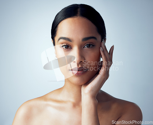 Image of Skincare, portrait and woman in studio for natural, cosmetic and dermatology on grey background. Face, beauty and female model touching soft, smooth and glowing skin after luxury self care routine