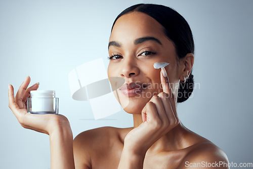 Image of Face cream, skincare and woman in studio for dermatology, wellness and hydration on grey background. Portrait, sunscreen and lady model relax with collagen, mask and lotion, beauty or facial product