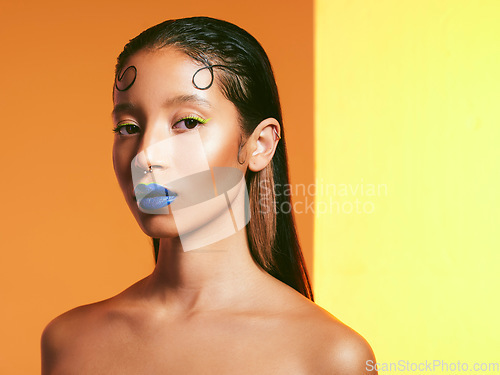 Image of Makeup, color art and portrait of woman in studio for cosmetics, eye shadow and beauty products. Creative, cosmetology and face of female person with blue lipstick for glamour, fashion and style