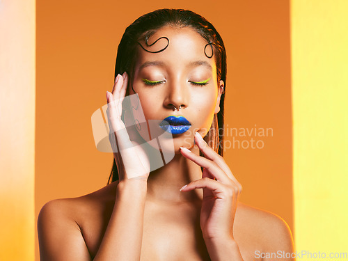 Image of Makeup, cosmetic art and face of woman in studio for cosmetics, eye shadow and beauty salon. Creative aesthetic, cosmetology and female person with blue lipstick for glamour, luxury style and glow