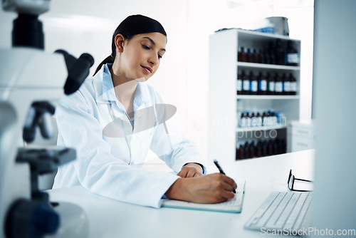 Image of Woman, scientist and writing notes in science research for discovery, breakthrough or information at lab. Female person or medical expert with notebook for scientific data or results in laboratory