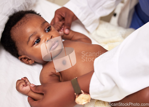 Image of African, little baby and bed for health checkup with doctor or paediatrician with infant or healthcare clinic and medical wellness. Child patient, consulting and expert with toddler in the hospital