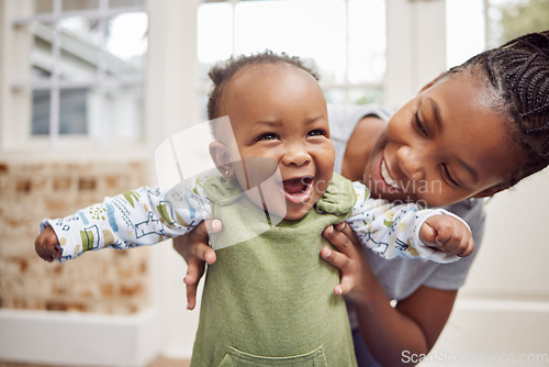 Image of Love, woman with baby and in living room smile at their home. Happy family or care, happiness or comic and black female person with newborn laughing or smiling at their house indoors for support