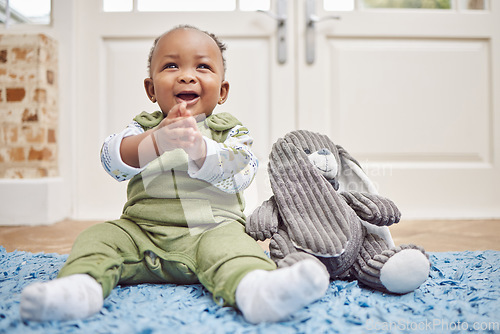 Image of Smile, baby and black child clapping in home, having fun or enjoying teddy bear. African newborn, children and toddler, kid and young infant play, happy or applause for childhood development in house