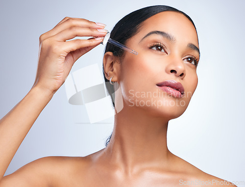 Image of Beauty serum, woman cosmetics and skincare with dermatology and face cleaning. Wellness, hyaluronic acid and young female model with skin glow product and treatment with care and dropper in studio