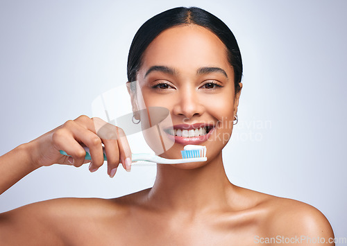 Image of Woman, brushing teeth and studio portrait with smile for self care, dental wellness or health by white background. Girl, dentistry model and toothbrush with toothpaste, product and happy for cleaning