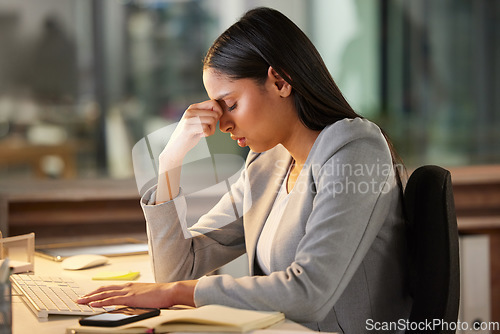 Image of Headache, stress and sad business woman in night office for burnout, fatigue or mental health problem. Crisis, pain and depressed or tired professional person at desk for mistake, depression or fail