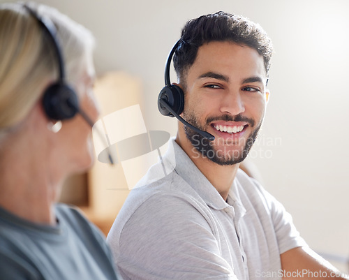 Image of Call center, team and man with headset for support, customer service or telemarketing. Woman and male agent or consultant talking with a smile for sales, contact us and help desk or crm teamwork