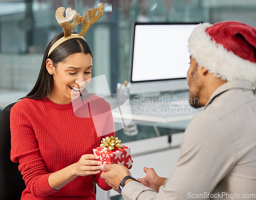 Image of Christmas gift, office surprise and couple of friends at work with present and box. Holiday, event presents and giving a party package to a woman employee with love for celebration at workplace