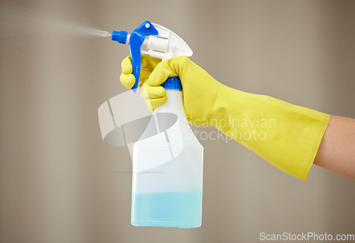 Image of Hand, cleaning and spray for house work, home hygiene and spring clean in apartment with gloves. Hands, bottle spraying and washing product for housekeeper, maid and health protection from virus