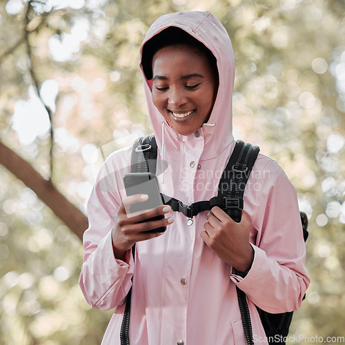 Image of Black woman, phone and smile for hiking communication, social media or chatting in nature. Happy African female person or hiker smiling on mobile smartphone for trekking, travel or online location