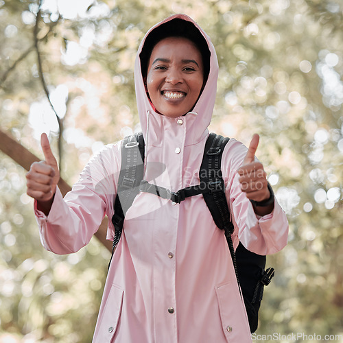 Image of Black woman, portrait smile and hiking with thumbs up for success, winning or achievement in nature. Happy African female person or hiker smiling and showing thumb emoji, yes sign or like in trekking