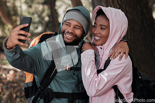 Image of Black couple, hiking and hug for selfie, profile picture or vlog in travel adventure together in nature. African man and woman hiker hugging for photo, memory or social media and trekking in forest