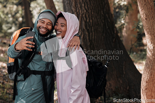 Image of Happy, black couple and hiking in hug for selfie, profile picture or vlog in travel adventure in nature. African man and woman hiker hugging for photo, memory or social media and trekking in forest