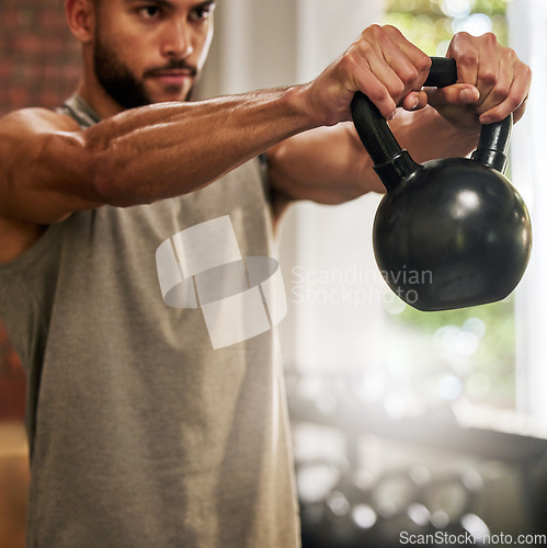 Image of Fitness, muscle and man with kettle bell in gym for exercise, bodybuilder training and workout. Sports, motivation and serious male person lifting weights for wellness, healthy body and strength