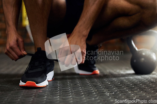 Image of Tie shoes, man hands and gym floor for fitness, strength training and exercise. Athlete feet, sport routine and male person prepare to start workout and wellness class at health center with sneakers