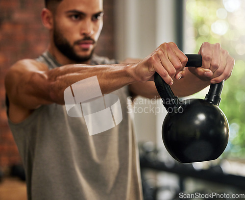 Image of Fitness, training and man with kettle bell in gym for exercise, bodybuilder workout and muscle strength. Sports, motivation and serious male person lift weights for wellness, healthy body and cardio
