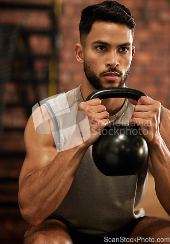 Image of Weightlifting, training and man with kettle bell in gym for exercise, bodybuilder and fitness workout. Sports, muscle and serious male person squat with weight for wellness, healthy body and strength