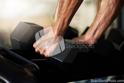 Image of Hands, training and man exercise with weights in a gym for strength, wellness and health for workout routine, Sport, muscle and closeup of person with dumbbell for power lifting of strong bodybuilder