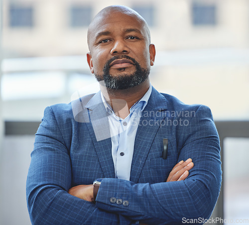 Image of Confidence, crossed arms and portrait of a businessman in his office with a serious face expression. Career, professional and confident African male executive ceo posing in the modern workplace.