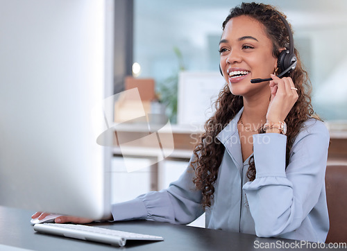 Image of Customer service, computer and a woman consulting in her office for telemarketing, sales or assistance. Call center, support and crm with a happy young female employee working online using a headset