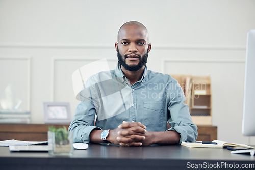 Image of Business, portrait and black man at desk in office, startup or entrepreneur focus on planning, strategy and career. Businessman, working and confident mindset, motivation and commitment to company