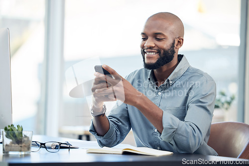 Image of Black man in office, check social media on smartphone and smile at meme, lunch break and communication. Male employee at workplace, using phone and technology, mobile app and contact with chat