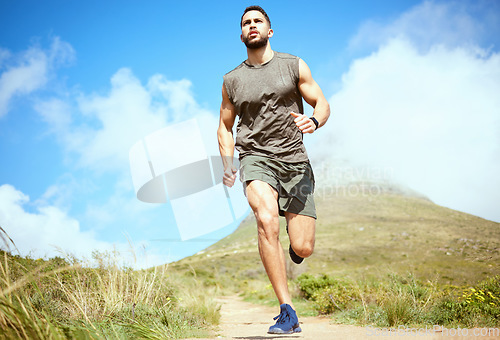 Image of Man, fitness and running on mountain for exercise, cardio workout or training in the nature outdoors. Male person, athlete or runner in sports outdoor run, hiking or trekking for healthy wellness