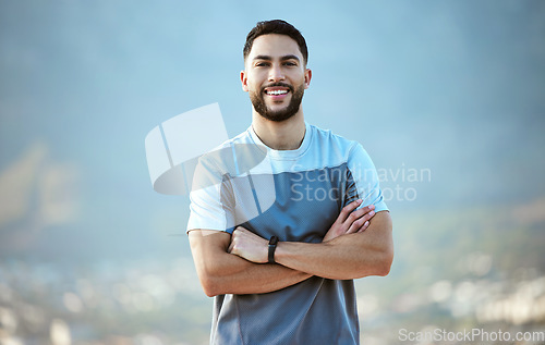 Image of Fitness, man and outdoor for a run or workout with a smile and arms crossed for motivation. Portrait of a male athlete person in nature for cardio training, running or health and wellness goals