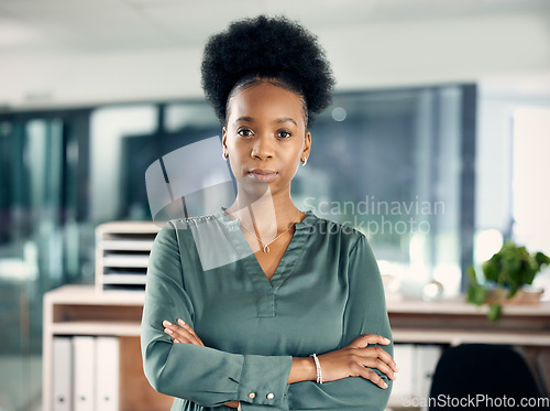 Image of Serious, crossed arms and portrait of a businesswoman in the office with vision, leadership or ideas. Professional, corporate and young African female hr manager standing with pride in the workplace.